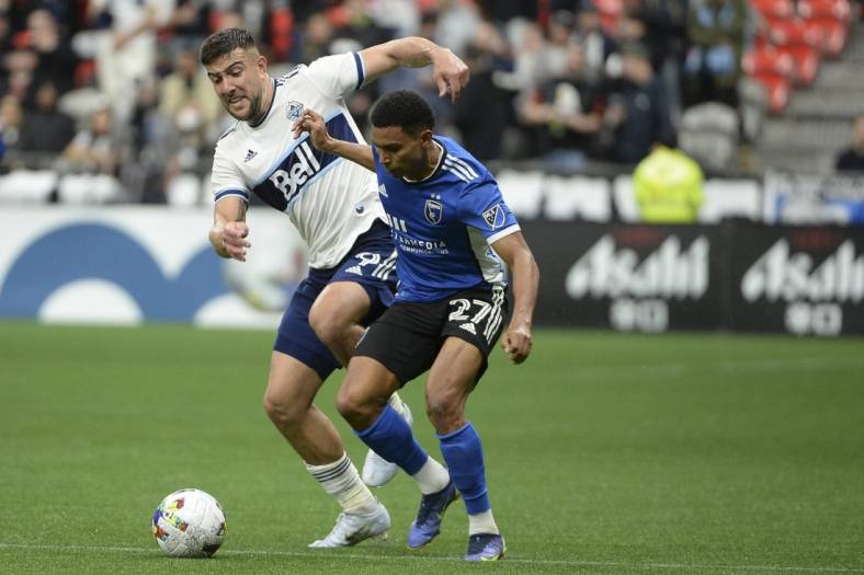 May 14, 2022; Vancouver, British Columbia, CAN;  San Jose Earthquakes defender Marcos Lopez (27) battles for the ball against Vancouver Whitecaps forward Lucas Cavallini (9) during the second half at BC Place. Mandatory Credit: Anne-Marie Sorvin-USA TODAY Sports