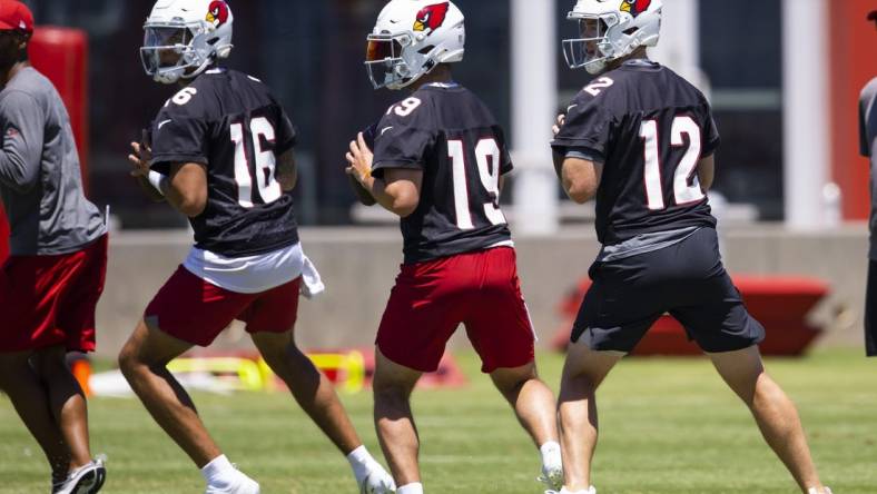 Jun 6, 2022; Tempe, Arizona, USA; Arizona Cardinals quarterback Colt McCoy (12), Trace McSorley (19) and Jarrett Guarantano (16) during OTA workouts at the teams training facility. Mandatory Credit: Mark J. Rebilas-USA TODAY Sports