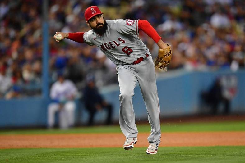 Jun 14, 2022; Los Angeles, California, USA; Los Angeles Angels third baseman Anthony Rendon (6) throws to first after fielding the ball hit for a single by Los Angeles Dodgers shortstop Trea Turner (6) during the fourth inning at Dodger Stadium. Mandatory Credit: Gary A. Vasquez-USA TODAY Sports