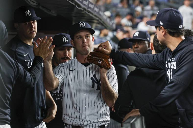 Jun 16, 2022; Bronx, New York, USA; New York Yankees relief pitcher Ryan Weber (85) is congratulated by teammates after being relieved from the game during the seventh inning against the Tampa Bay Rays at Yankee Stadium. Mandatory Credit: Vincent Carchietta-USA TODAY Sports