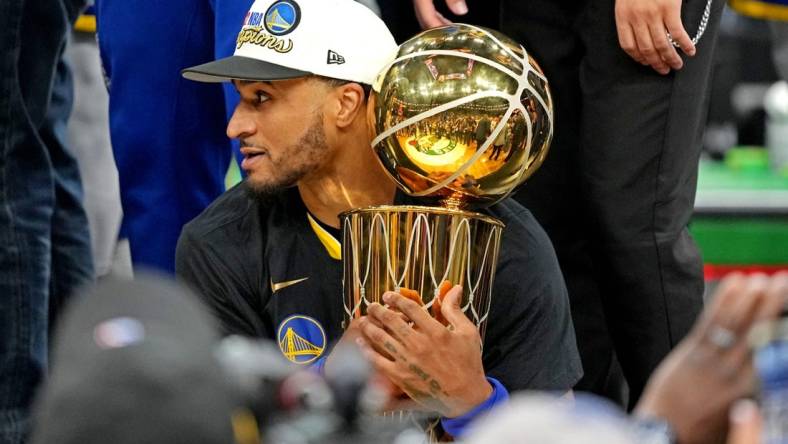 Jun 16, 2022; Boston, Massachusetts, USA; Golden State Warriors guard Gary Payton II (0) holds the the Larry O'Brien Championship Trophy after the Golden State Warriors beat the Boston Celtics in game six of the 2022 NBA Finals to win the NBA Championship at TD Garden. Mandatory Credit: Kyle Terada-USA TODAY Sports