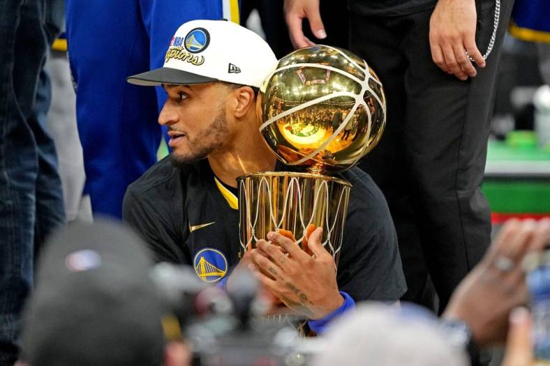Jun 16, 2022; Boston, Massachusetts, USA; Golden State Warriors guard Gary Payton II (0) holds the the Larry O'Brien Championship Trophy after the Golden State Warriors beat the Boston Celtics in game six of the 2022 NBA Finals to win the NBA Championship at TD Garden. Mandatory Credit: Kyle Terada-USA TODAY Sports