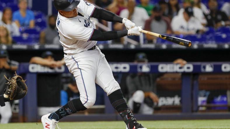 Jul 14, 2022; Miami, Florida, USA; Miami Marlins designated hitter Avisail Garcia (24) hits a single in the eleventh inning against the Pittsburgh Pirates at loanDepot Park. Mandatory Credit: Sam Navarro-USA TODAY Sports