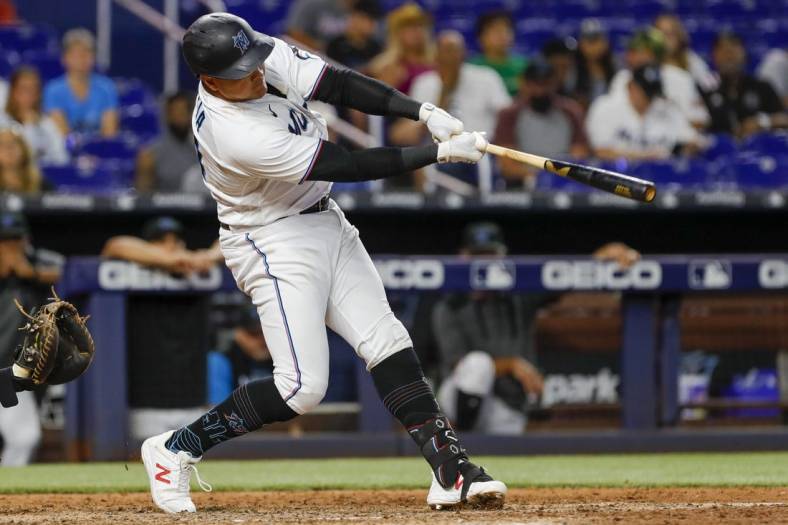 Jul 14, 2022; Miami, Florida, USA; Miami Marlins designated hitter Avisail Garcia (24) hits a single in the eleventh inning against the Pittsburgh Pirates at loanDepot Park. Mandatory Credit: Sam Navarro-USA TODAY Sports