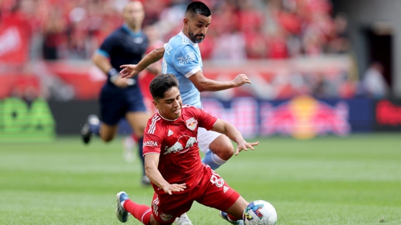 Jul 17, 2022; Harrison, New Jersey, USA; New York City midfielder Maximiliano Moralez (10) and New York Red Bulls midfielder Frankie Amaya (8) fight for the ball during the first half at Red Bull Arena. Mandatory Credit: Brad Penner-USA TODAY Sports