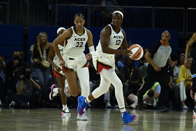 Jul 26, 2022; Chicago, IL, USA;  Las Vegas Aces guard Chelsea Gray (12) moves the ball with Las Vegas Aces forward A'ja Wilson (22) against the Chicago Sky during the second half of the Commissioners Cup-Championships at Wintrust Arena. Mandatory Credit: Matt Marton-USA TODAY Sports