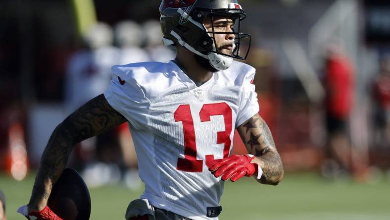 Jul 27, 2022; Tampa, FL, USA;  Tampa Bay Buccaneers wide receiver Mike Evans (13) works out during training camp at Advent Health Training Complex. Mandatory Credit: Kim Klement-USA TODAY Sports