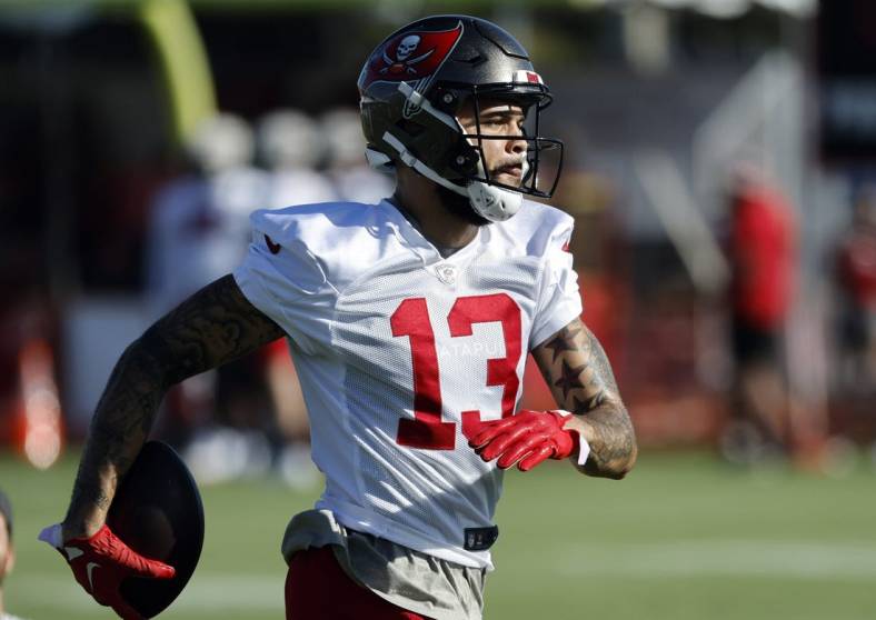 Jul 27, 2022; Tampa, FL, USA;  Tampa Bay Buccaneers wide receiver Mike Evans (13) works out during training camp at Advent Health Training Complex. Mandatory Credit: Kim Klement-USA TODAY Sports