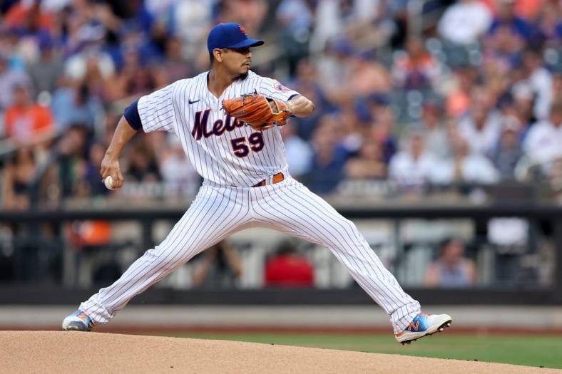 Aug 4, 2022; New York City, New York, USA; New York Mets starting pitcher Carlos Carrasco (59) pitches against the Atlanta Braves during the first inning at Citi Field. Mandatory Credit: Brad Penner-USA TODAY Sports