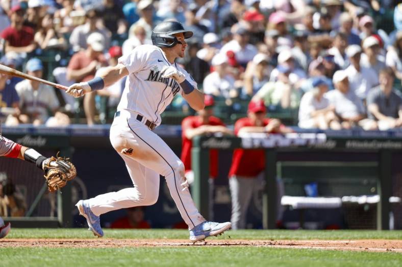 Aug 6, 2022; Seattle, Washington, USA; Seattle Mariners center fielder Jarred Kelenic (10) hits a single against the Los Angeles Angels during the fifth inning at T-Mobile Park. Mandatory Credit: Joe Nicholson-USA TODAY Sports