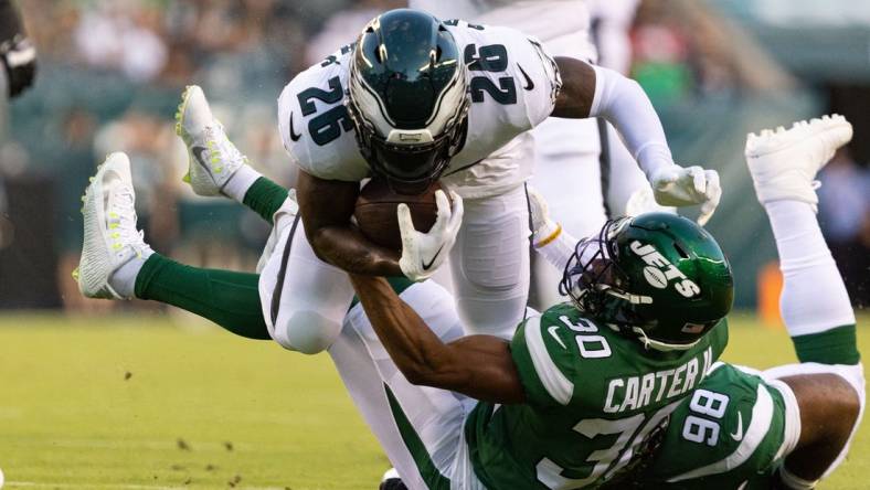 Aug 12, 2022; Philadelphia, Pennsylvania, USA; New York Jets cornerback Michael Carter II (30) tackles Philadelphia Eagles running back Miles Sanders (26) during the first quarter at Lincoln Financial Field. Mandatory Credit: Bill Streicher-USA TODAY Sports