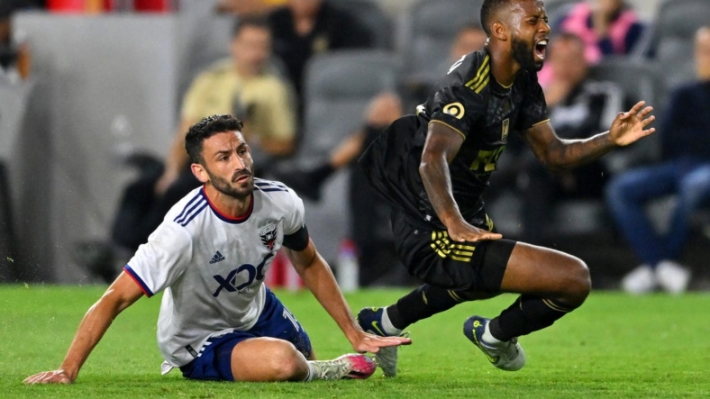 Aug 16, 2022; Los Angeles, California, USA; D.C. United defender Steve Birnbaum (15) is shown a red card for a second caution by referee Ramy Touchan (not pictured) at after a foul on LAFC midfielder Kellyn Acosta (23) in the second half of the game at Banc of California Stadium. Mandatory Credit: Jayne Kamin-Oncea-USA TODAY Sports