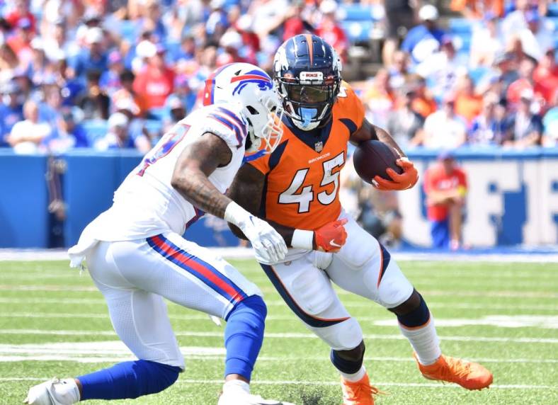 Aug 20, 2022; Orchard Park, New York, USA; Denver Broncos running back Steve Scott III (45) prepares to be hit by Buffalo Bills cornerback Christian Benford (47) in the second quarter of a pre-season game at Highmark Stadium. Mandatory Credit: Mark Konezny-USA TODAY Sports