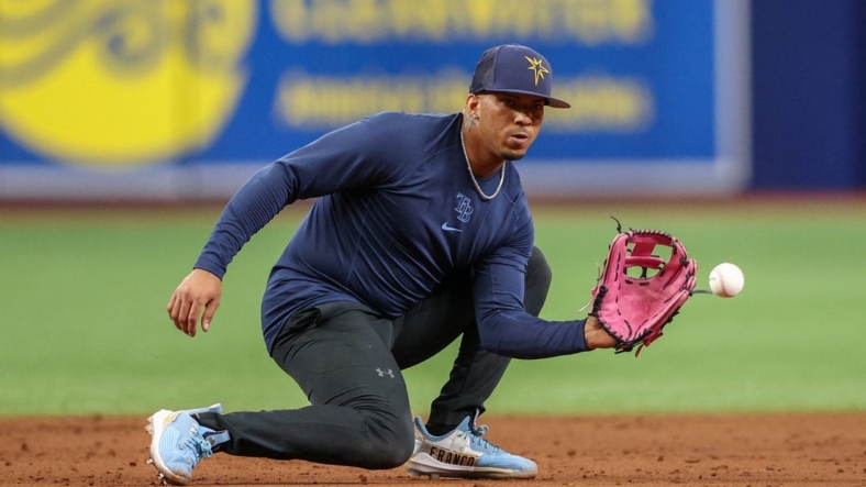 Aug 23, 2022; St. Petersburg, Florida, USA;  Tampa Bay Rays shortstop Wander Franco (5) takes ground balls before a game against the Los Angeles Angels at Tropicana Field. Mandatory Credit: Nathan Ray Seebeck-USA TODAY Sports