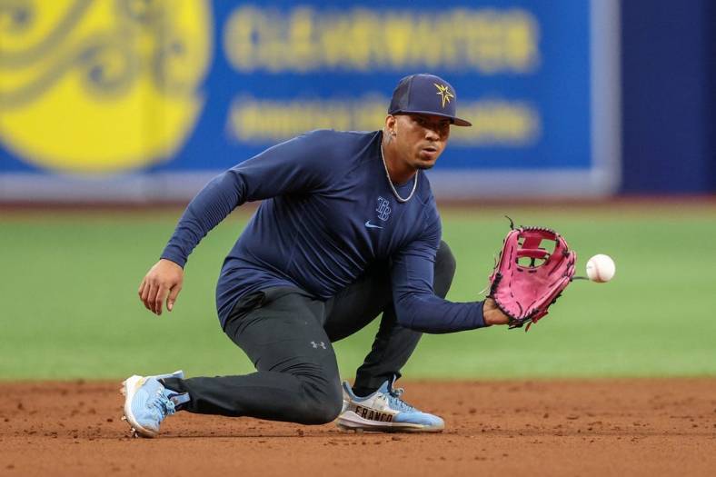 Aug 23, 2022; St. Petersburg, Florida, USA;  Tampa Bay Rays shortstop Wander Franco (5) takes ground balls before a game against the Los Angeles Angels at Tropicana Field. Mandatory Credit: Nathan Ray Seebeck-USA TODAY Sports