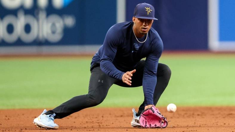 Aug 23, 2022; St. Petersburg, Florida, USA;  Tampa Bay Rays shortstop Wander Franco (5) takes ground balls before a game against the Los Angeles Angels at Tropicana Field. Mandatory Credit: Nathan Ray Seebeck-USA TODAY Sports