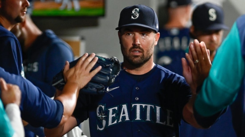 Aug 23, 2022; Seattle, Washington, USA; Seattle Mariners starting pitcher Robbie Ray (38) celebrates in the dugout after striking out the side in the sixth inning at T-Mobile Park. Mandatory Credit: Steven Bisig-USA TODAY Sports