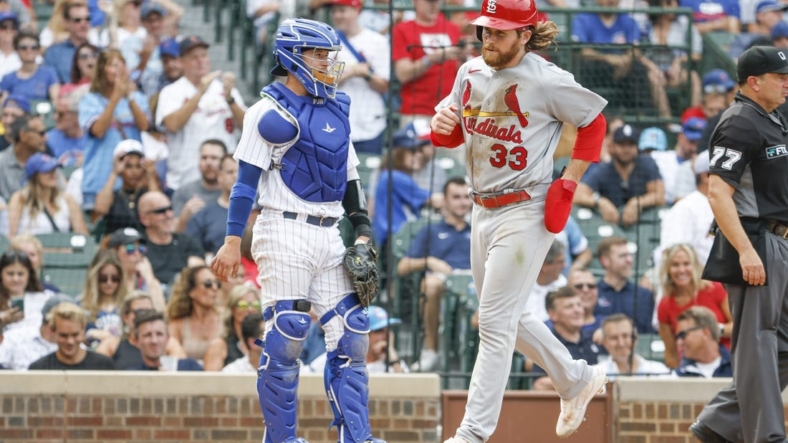 Aug 25, 2022; Chicago, Illinois, USA; St. Louis Cardinals left fielder Brendan Donovan (33) scores a run against the Chicago Cubs during the eight inning at Wrigley Field. Mandatory Credit: Kamil Krzaczynski-USA TODAY Sports