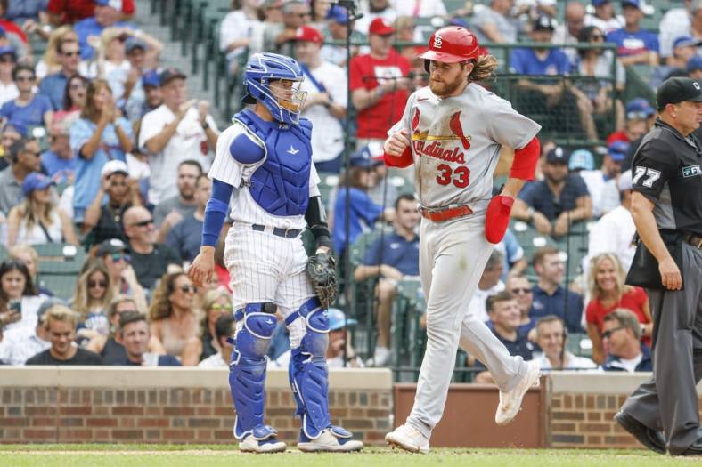 Aug 25, 2022; Chicago, Illinois, USA; St. Louis Cardinals left fielder Brendan Donovan (33) scores a run against the Chicago Cubs during the eight inning at Wrigley Field. Mandatory Credit: Kamil Krzaczynski-USA TODAY Sports