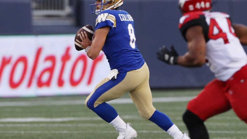 Aug 25, 2022; Winnipeg, Manitoba, CAN;  Winnipeg Blue Bombers quarterback Zach Collaros (8) looks for a receiver during the first half against the Calgary Stampeders at IG Field. Mandatory Credit: Bruce Fedyck-USA TODAY Sports
