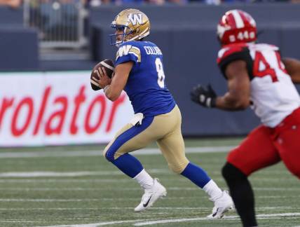 Aug 25, 2022; Winnipeg, Manitoba, CAN;  Winnipeg Blue Bombers quarterback Zach Collaros (8) looks for a receiver during the first half against the Calgary Stampeders at IG Field. Mandatory Credit: Bruce Fedyck-USA TODAY Sports