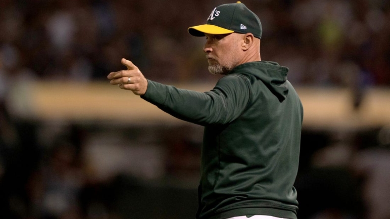 Aug 25, 2022; Oakland, California, USA;  Oakland Athletics manager Mark Kotsay (7) signals during the third inning against the New York Yankees at RingCentral Coliseum. Mandatory Credit: Stan Szeto-USA TODAY Sports