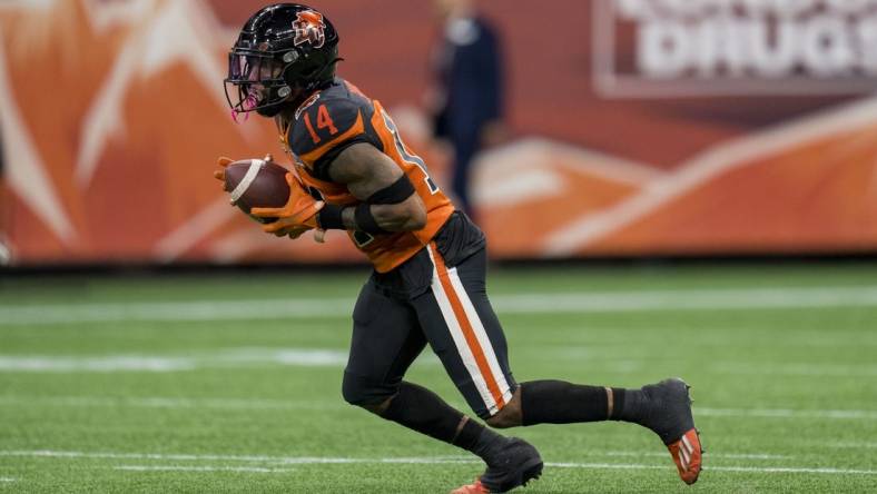 Aug 26, 2022; Vancouver, British Columbia, CAN; BC Lions defensive back Marcus Sayles (14) returns a punt against the Saskatchewan Roughriders in the second half at BC Place. Mandatory Credit: Bob Frid-USA TODAY Sports