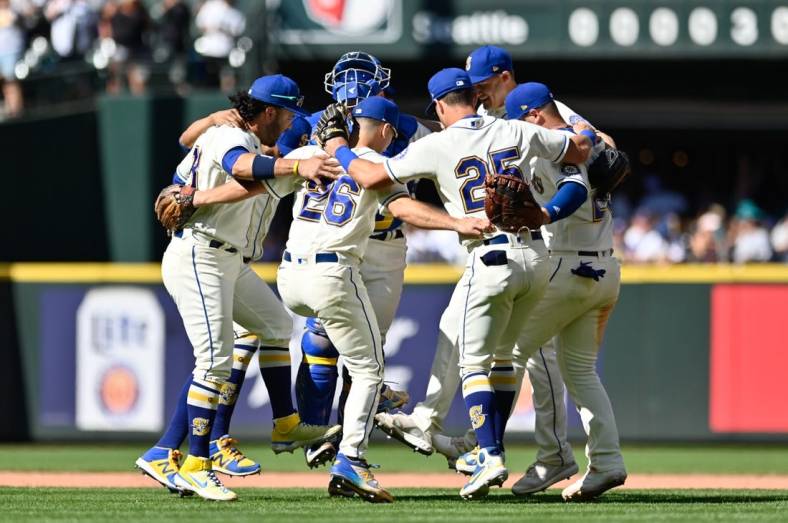 Aug 28, 2022; Seattle, Washington, USA; The Seattle Mariners infielders celebrate defeating the Cleveland Guardians at T-Mobile Park. Seattle defeated against the Cleveland Guardians 4-0. Mandatory Credit: Steven Bisig-USA TODAY Sports