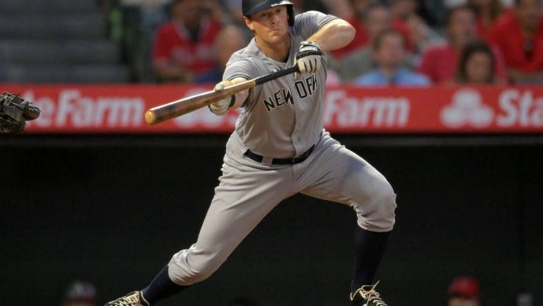 Aug 29, 2022; Anaheim, California, USA;  New York Yankees third baseman DJ LeMahieu (26) lays down a sacrifice bunt to score shortstop Isiah Kiner-Falefa (not pictured) in the fourth inning against the Los Angeles Angels at Angel Stadium. Mandatory Credit: Jayne Kamin-Oncea-USA TODAY Sports