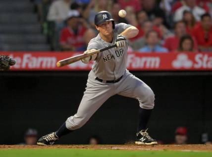 Aug 29, 2022; Anaheim, California, USA;  New York Yankees third baseman DJ LeMahieu (26) lays down a sacrifice bunt to score shortstop Isiah Kiner-Falefa (not pictured) in the fourth inning against the Los Angeles Angels at Angel Stadium. Mandatory Credit: Jayne Kamin-Oncea-USA TODAY Sports
