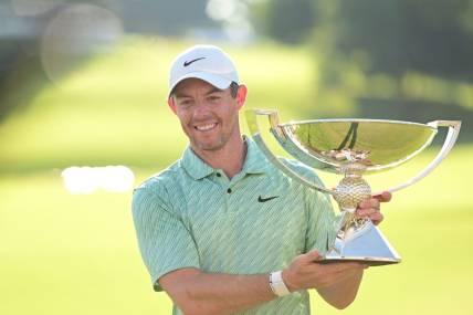 Aug 28, 2022; Atlanta, Georgia, USA; Rory McIlroy poses with the FedEx Trophy after winning the TOUR Championship golf tournament. Mandatory Credit: Adam Hagy-USA TODAY Sports
