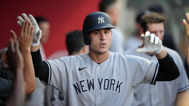 Aug 30, 2022; Anaheim, California, USA; New York Yankees first baseman Anthony Rizzo (48) celebrates after hitting a solo home run in the second inning as Los Angeles Angels catcher Max Stassi (33) wqtches at Angel Stadium. Mandatory Credit: Kirby Lee-USA TODAY Sports