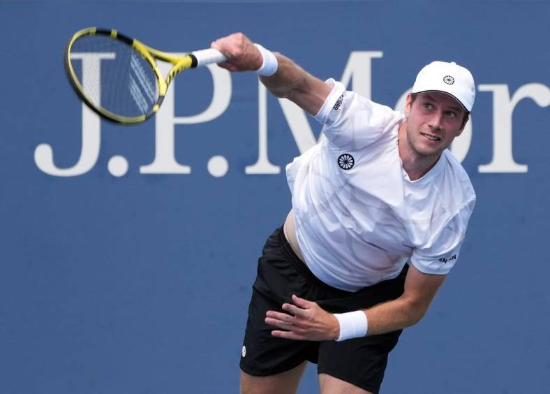 Aug 31, 2022; Flushing, NY, USA;  Botic van De Zandschulp of the Netherlands serves against Corentin Moutet of France on day three of the 2022 U.S. Open tennis tournament at USTA Billie Jean King Tennis Center. Mandatory Credit: Jerry Lai-USA TODAY Sports