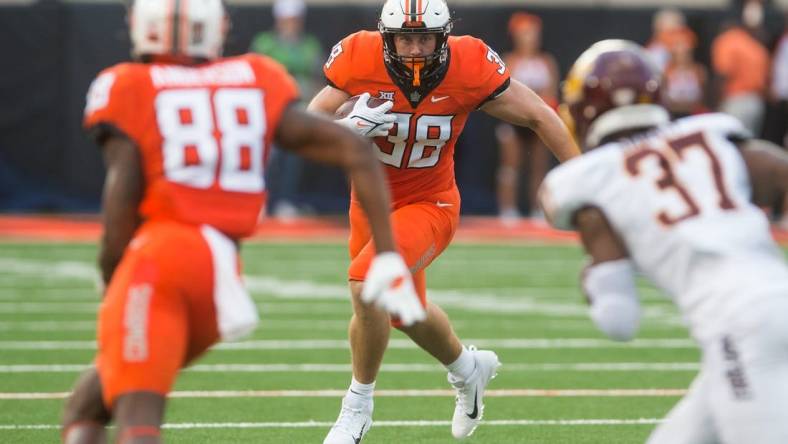 Sep 1, 2022; Stillwater, Oklahoma, USA; Oklahoma State Cowboys fullback Jake Schultz (38) turns to run after a catch during the second quarter against the Central Michigan Chippewas at Boone Pickens Stadium. Mandatory Credit: Brett Rojo-USA TODAY Sports