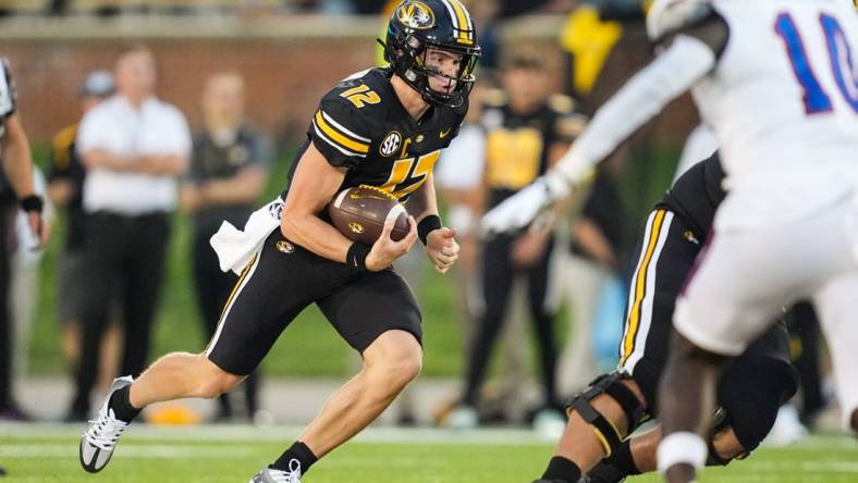 Sep 1, 2022; Columbia, Missouri, USA; Missouri Tigers quarterback Brady Cook (12) runs the ball against the Louisiana Tech Bulldogs during the first half at Faurot Field at Memorial Stadium. Mandatory Credit: Jay Biggerstaff-USA TODAY Sports