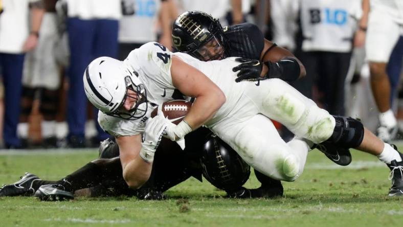 Purdue Boilermakers linebacker Clyde Washington (42) and Purdue Boilermakers safety Chris Jefferson (17) tackle Penn State Nittany Lions tight end Tyler Warren (44) during the NCAA football game, Thursday, Sept. 1, 2022, at Ross-Ade Stadium in West Lafayette, Ind. Penn State won 35-31.

Purduepennstatefb090122 Am01374