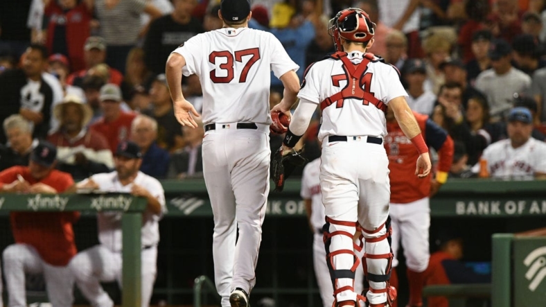 Sep 2, 2022; Boston, Massachusetts, USA; Boston Red Sox starting pitcher Nick Pivetta (37) limps off of the field with catcher Connor Wong (74) after the third inning of a game against the Texas Rangers at Fenway Park. Mandatory Credit: Brian Fluharty-USA TODAY Sports