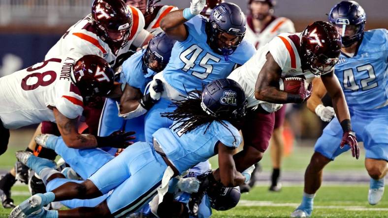 Sep 2, 2022; Norfolk, Virginia, USA;  Virginia Tech Hokies running back Jalen Holston (0) runs the ball during the second quarter against Old Dominion Monarchs defensive tackle Denzel Lowry (45) at Kornblau Field at S.B. Ballard Stadium. Mandatory Credit: Peter Casey-USA TODAY Sports