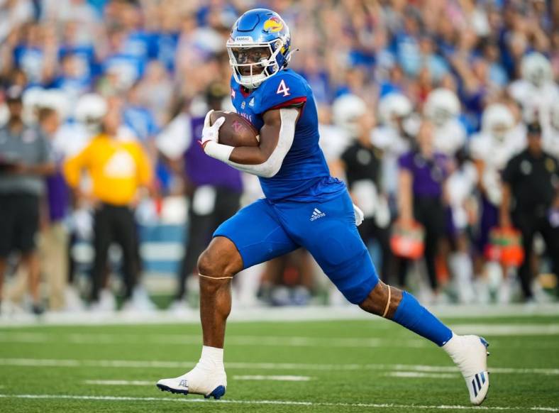 Sep 2, 2022; Lawrence, Kansas, USA; Kansas Jayhawks running back Devin Neal (4) runs for a touchdown against the Tennessee Tech Golden Eagles during the first half at David Booth Kansas Memorial Stadium. Mandatory Credit: Jay Biggerstaff-USA TODAY Sports