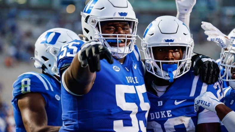 Sep 2, 2022; Durham, North Carolina, USA;  Duke Blue Devils offensive lineman Andre Harris (55) and Duke Blue Devils running back Jaylen Coleman (22) celebrate during first half of the game against Temple University at Wallace Wade Stadium. Mandatory Credit: Jaylynn Nash-USA TODAY Sports