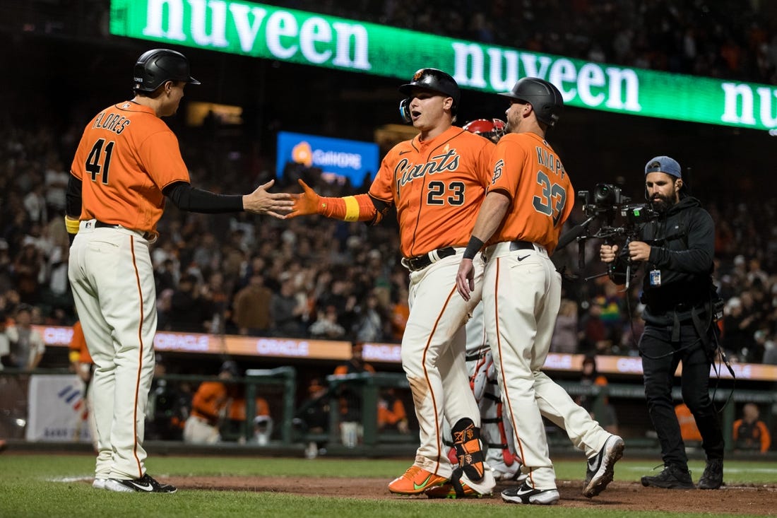 Sep 2, 2022; San Francisco, California, USA; San Francisco Giants left fielder Joc Pederson (23) celebrates with catcher Andrew Knapp (33) and designated hitter Wilmer Flores (41) after hitting a three-run home run against the Philadelphia Phillies during the second inning at Oracle Park. Mandatory Credit: John Hefti-USA TODAY Sports