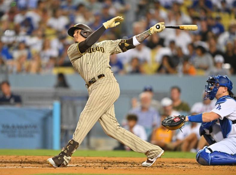 Sep 2, 2022; Los Angeles, California, USA;  San Diego Padres third baseman Manny Machado (13) watches the flight of the ball a two run home run off Los Angeles Dodgers starting pitcher Dustin May (85) in the third inning at Dodger Stadium. Mandatory Credit: Jayne Kamin-Oncea-USA TODAY Sports