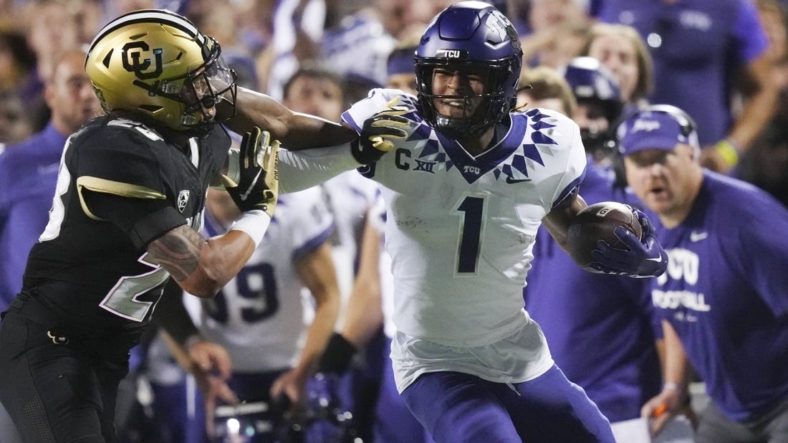 Sep 2, 2022; Boulder, Colorado, USA; TCU Horned Frogs wide receiver Quentin Johnston (1) stiff arms Colorado Buffaloes safety Isaiah Lewis (23) in the second quarter at Folsom Field. Mandatory Credit: Ron Chenoy-USA TODAY Sports