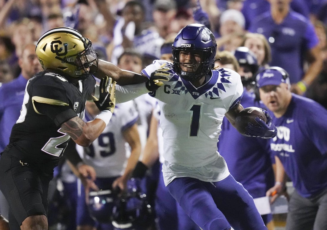 Sep 2, 2022; Boulder, Colorado, USA; TCU Horned Frogs wide receiver Quentin Johnston (1) stiff arms Colorado Buffaloes safety Isaiah Lewis (23) in the second quarter at Folsom Field. Mandatory Credit: Ron Chenoy-USA TODAY Sports