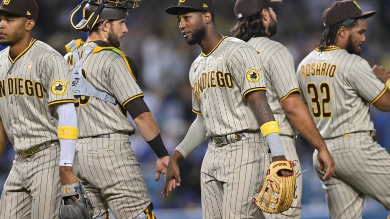 Sep 2, 2022; Los Angeles, California, USA;  San Diego Padres catcher Austin Nola (26) shakes hands with San left fielder Jurickson Profar (10) after the final out of the ninth inning defeating the Los Angeles Dodgers at Dodger Stadium. Mandatory Credit: Jayne Kamin-Oncea-USA TODAY Sports