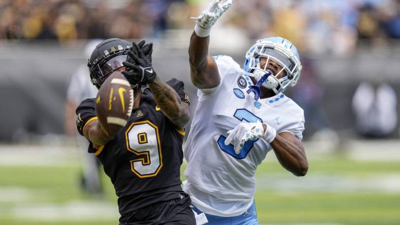 Sep 3, 2022; Boone, North Carolina, USA;Appalachian State Mountaineers wide receiver Christian Wells (9) cannot catch a pass while defended by North Carolina Tar Heels defensive back Storm Duck (3) during the first quarter at Kidd Brewer Stadium. Mandatory Credit: Jim Dedmon-USA TODAY Sports