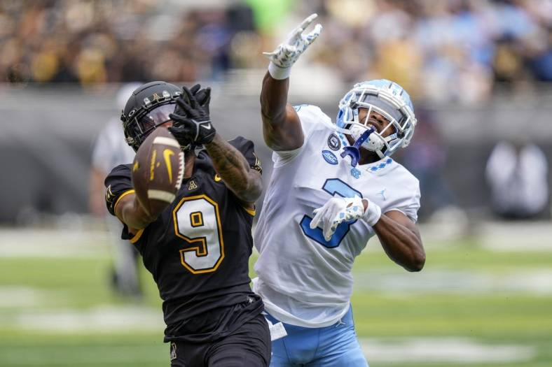 Sep 3, 2022; Boone, North Carolina, USA;Appalachian State Mountaineers wide receiver Christian Wells (9) cannot catch a pass while defended by North Carolina Tar Heels defensive back Storm Duck (3) during the first quarter at Kidd Brewer Stadium. Mandatory Credit: Jim Dedmon-USA TODAY Sports