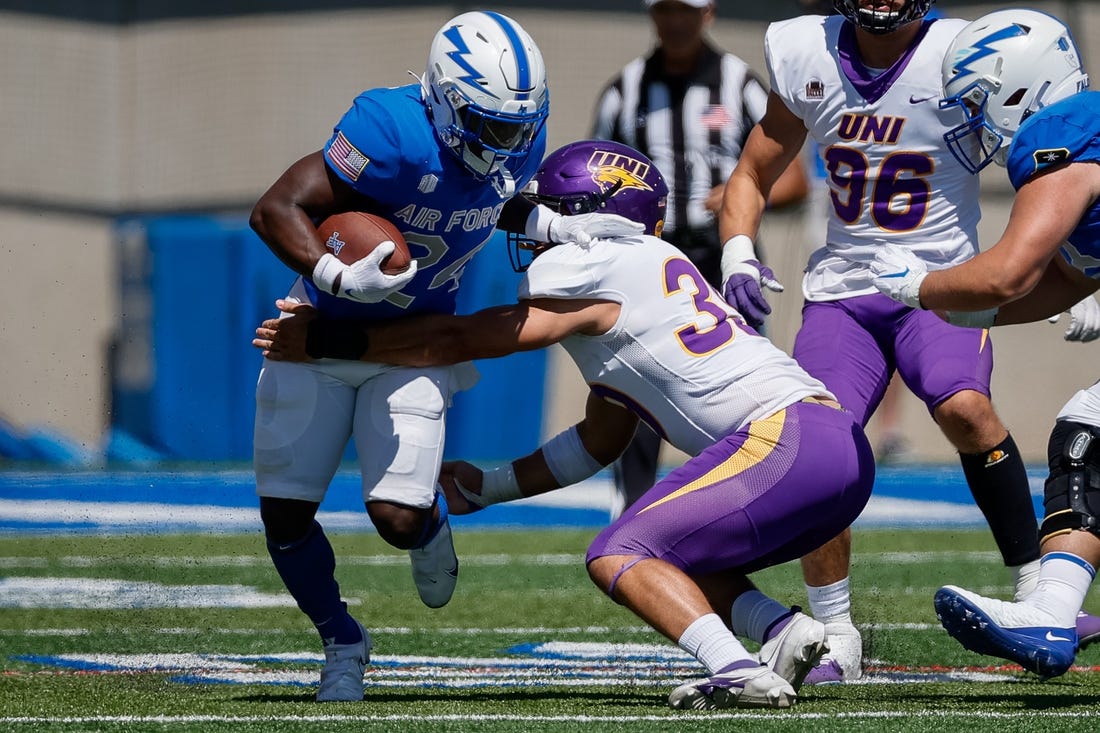 Sep 3, 2022; Colorado Springs, Colorado, USA; Air Force Falcons running back John Lee Eldridge III (24) runs through the tackle of Northern Iowa Panthers linebacker Cameron Baker (39) in the third quarter at Falcon Stadium. Mandatory Credit: Isaiah J. Downing-USA TODAY Sports