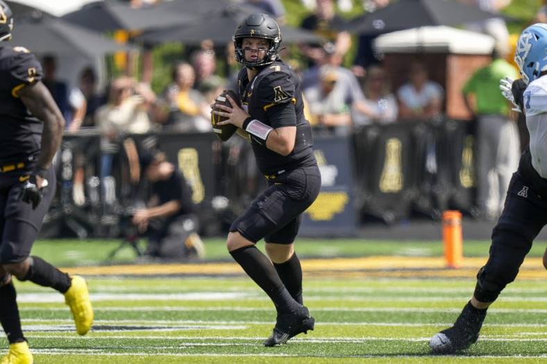Sep 3, 2022; Boone, North Carolina, USA; Appalachian State Mountaineers quarterback Chase Brice (7) looks down field for a receiver against the North Carolina Tar Heels during the second half at Kidd Brewer Stadium. Mandatory Credit: Jim Dedmon-USA TODAY Sports