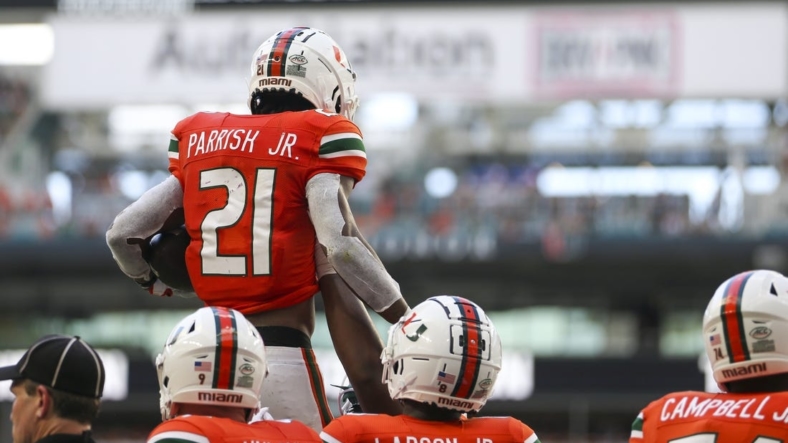Sep 3, 2022; Miami Gardens, Florida, USA; Miami Hurricanes running back Henry Parrish Jr. (21) celebrates with teammates after scoring during the second quarter against the Bethune Cookman Wildcats at Hard Rock Stadium. Mandatory Credit: Sam Navarro-USA TODAY Sports